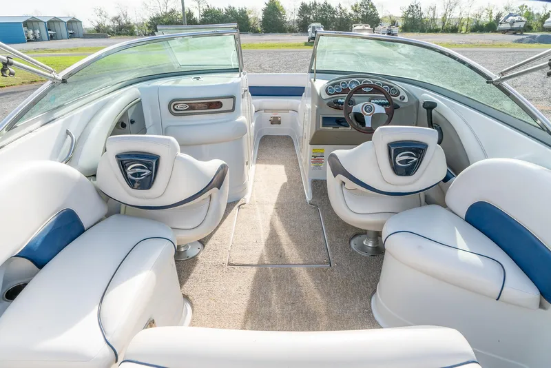 Slide: The Image of Interior of a 2012 Crownline Eclipse E2 boat with white and blue seating. - 12