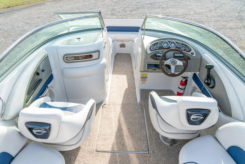 Slide: The Image of 2012 Crownline Eclipse E2 boat interior with white seating and modern dashboard. - 13