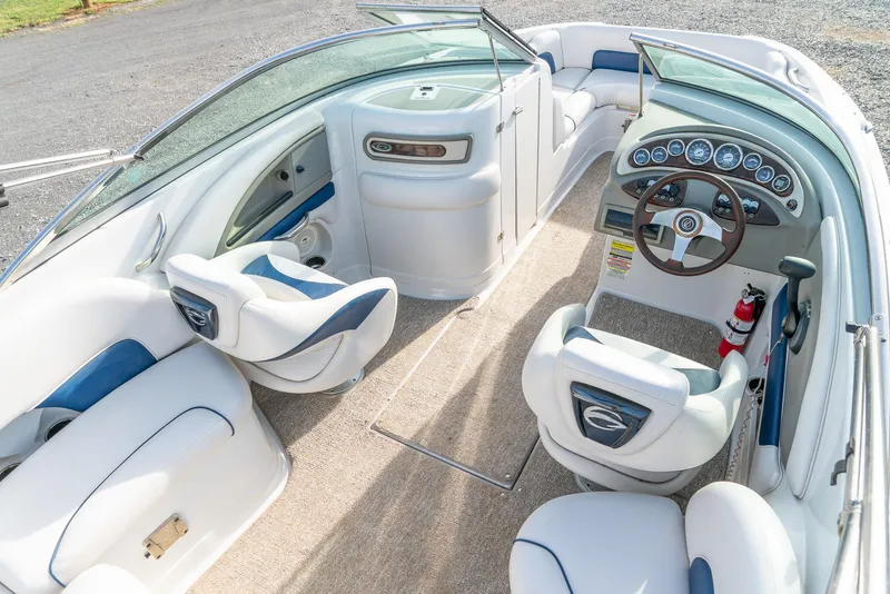 Slide: The Image of 2012 Crownline Eclipse E2 boat interior with white seating and dashboard. - 14