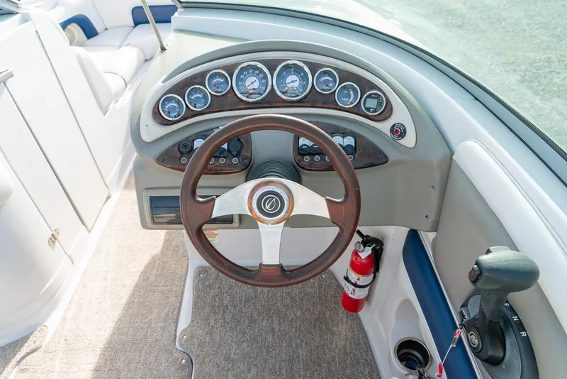 Slide: The Image of 2012 Crownline Eclipse E2 boat dashboard with steering wheel and gauges. - 16