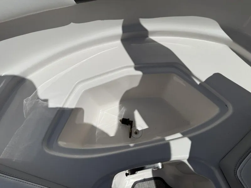 Slide: The Image of Storage compartment of 2022 Chaparral 23 SSi boat, featuring sleek white interior design. - 11