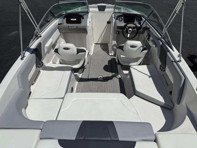 Slide: The Image of 2022 Chaparral 23 SSi boat interior with white seating and steering console. - 19