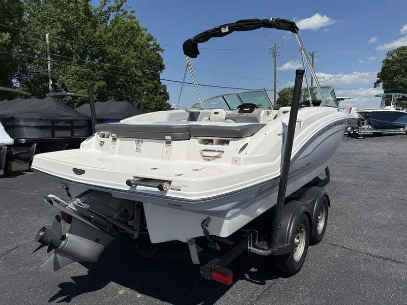 Slide: The Image of 2022 Chaparral 23 SSi boat on trailer, parked outdoors under clear sky. - 2