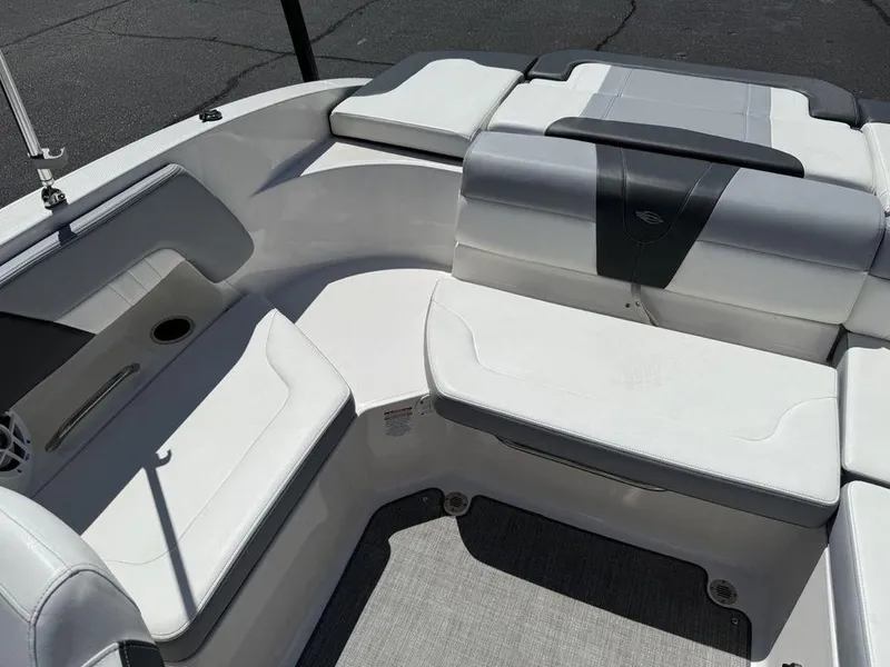 Slide: The Image of 2022 Chaparral 23 SSi boat interior with white seating and cup holder. - 20