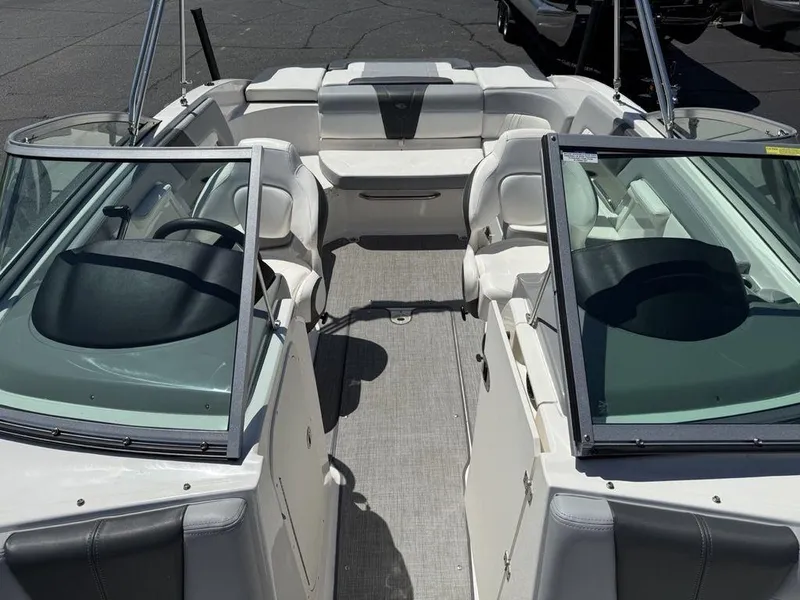 Slide: The Image of 2022 Chaparral 23 SSi boat interior with seating and steering wheel, viewed from above. - 21