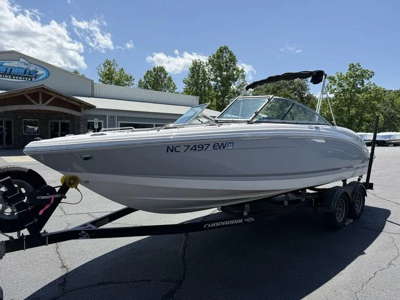 Slide: The Image of 2022 Chaparral 23 SSi boat on trailer outside dealership, sunny day. - 4