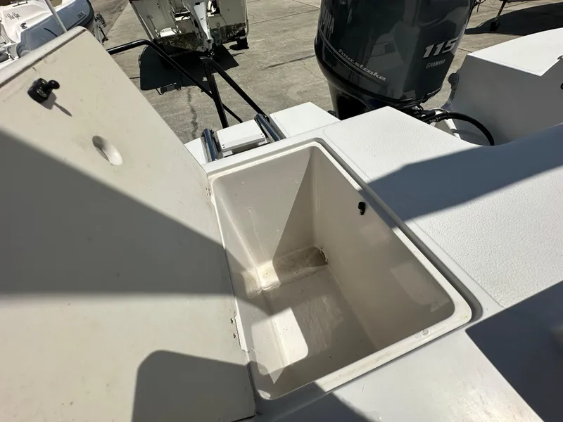 Slide: The Image of 2017 Starcraft MDX 191 OB boat with open storage compartment and Yamaha 115 outboard motor. - 11