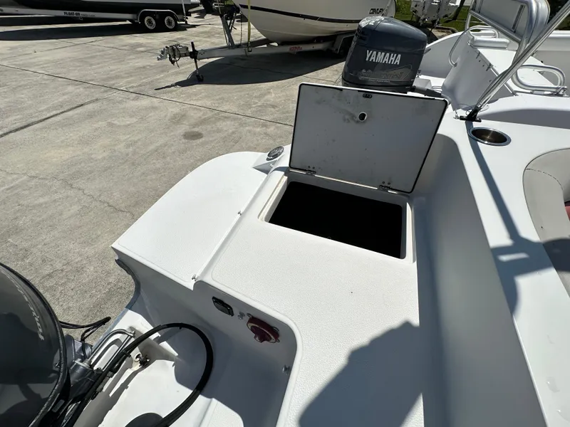 Slide: The Image of 2017 Starcraft MDX 191 OB boat with open storage compartment and Yamaha outboard motor. - 12