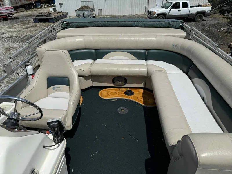 Slide: The Image of 1999 Smoker Craft 8526 Pleasure Isle I/O boat interior with beige seating and steering console. - 11
