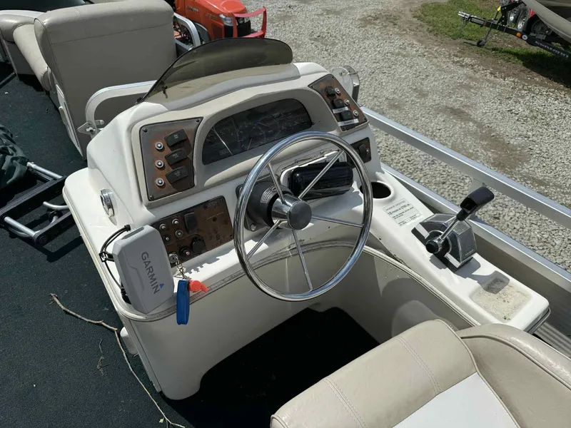 Slide: The Image of 1999 Smoker Craft 8526 Pleasure Isle I/O boat dashboard with steering wheel and controls. - 12