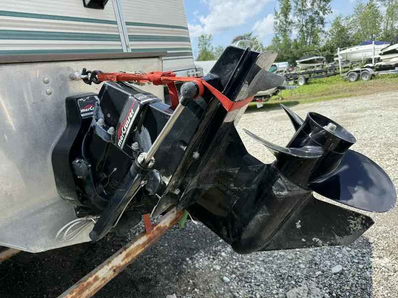 Slide: The Image of 1999 Smoker Craft 8526 Pleasure Isle I/O boat engine with MerCruiser outdrive, parked outdoors. - 16
