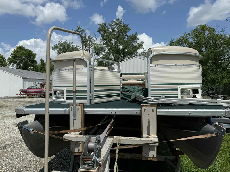 Slide: The Image of 1999 Smoker Craft 8526 Pleasure Isle I/O pontoon boat on trailer, outdoors. - 6