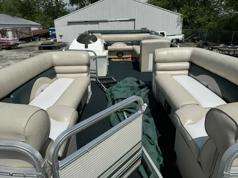 Slide: The Image of 1999 Smoker Craft 8526 Pleasure Isle I/O pontoon boat with spacious seating and green cover. - 7