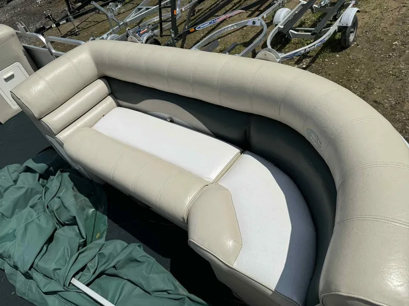 Slide: The Image of 1999 Smoker Craft 8526 Pleasure Isle I/O boat seating with beige upholstery and green cover. - 9