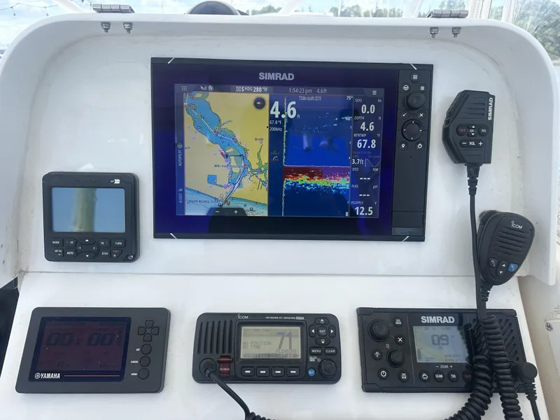 Slide: The Image of Control panel of a 2004 Contender 31 Fish Around boat with navigation and communication devices. - 10