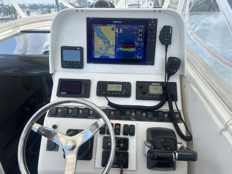 Slide: The Image of 2004 Contender 31 Fish Around boat dashboard with navigation and communication equipment. - 11