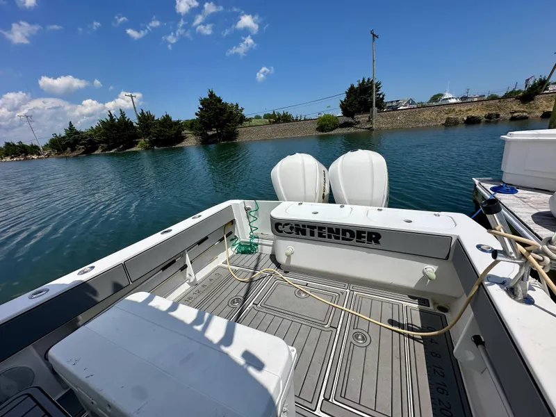 Slide: The Image of 2004 Contender 31 Fish Around boat docked by a serene waterway under a clear blue sky. - 5