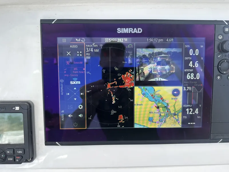 Slide: The Image of Simrad marine display on 2004 Contender 31 Fish Around, showing navigation and radar data. - 7