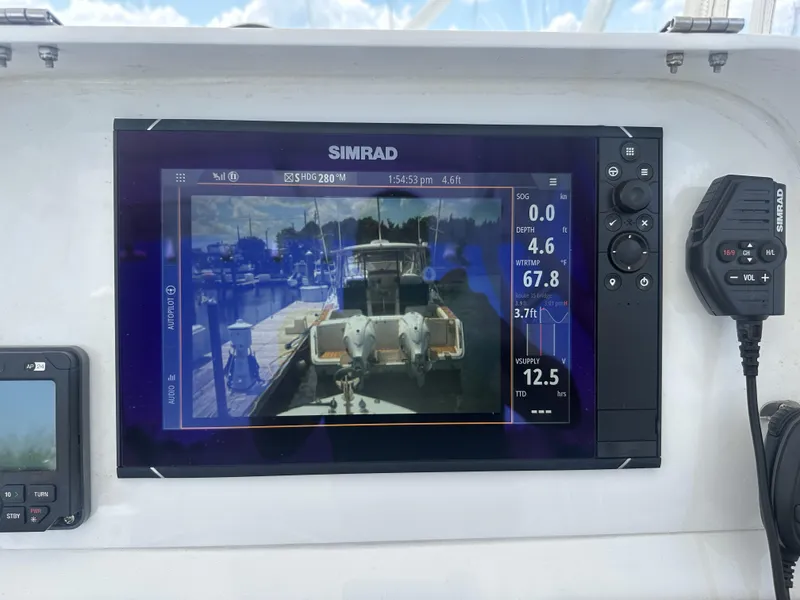Slide: The Image of Simrad marine display on 2004 Contender 31 Fish Around boat, showing navigation and depth data. - 9