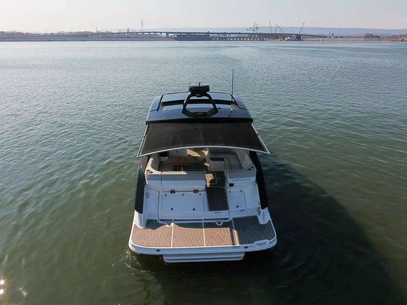 Slide: The Image of 2024 Sea Ray Sundancer 370 yacht on calm water, rear view. - 10