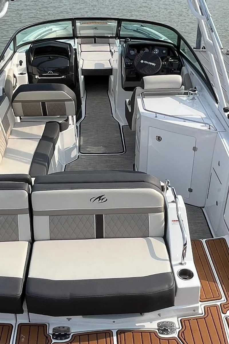 Slide: The Image of 2021 Monterey M6 boat interior with luxurious seating and modern dashboard on the water. - 3
