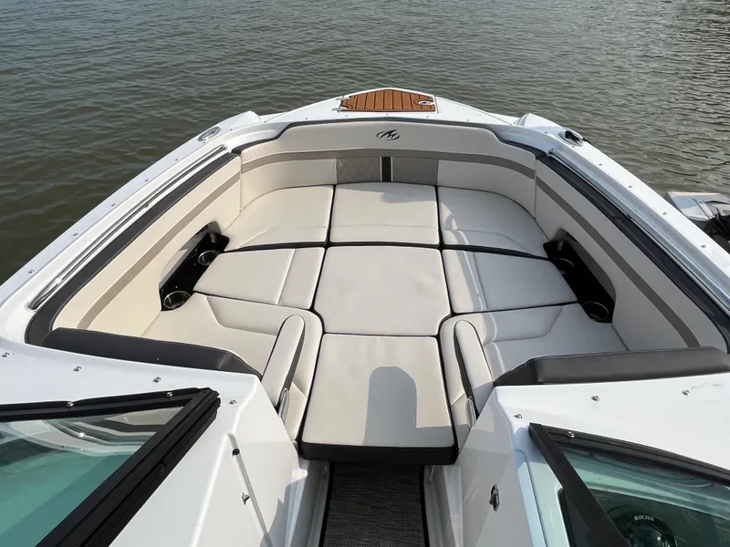 Slide: The Image of 2021 Monterey M6 boat with spacious seating, white upholstery, and cup holders on calm water. - 7