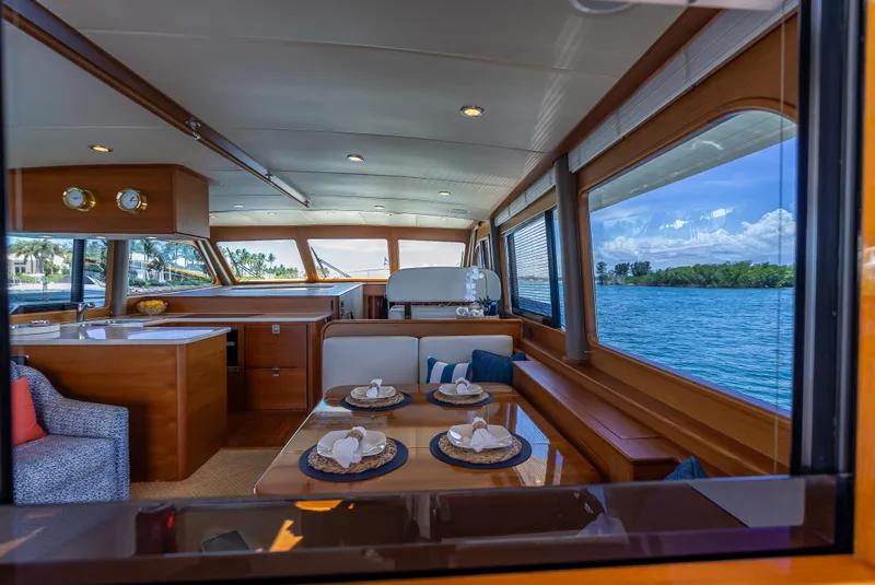 Slide: The Image of Luxurious 2018 Grand Banks GB60 yacht interior with elegant dining area and scenic ocean view. - 32