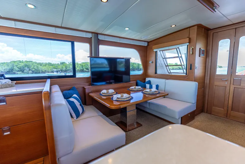 Slide: The Image of Luxurious 2018 Grand Banks GB60 yacht interior with dining area and scenic window views. - 35