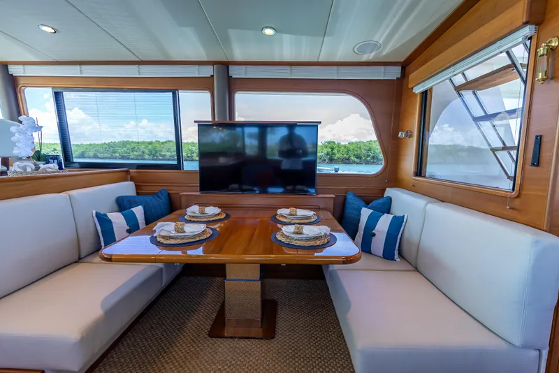 Slide: The Image of Luxurious 2018 Grand Banks GB60 yacht interior with elegant dining area and scenic views. - 36