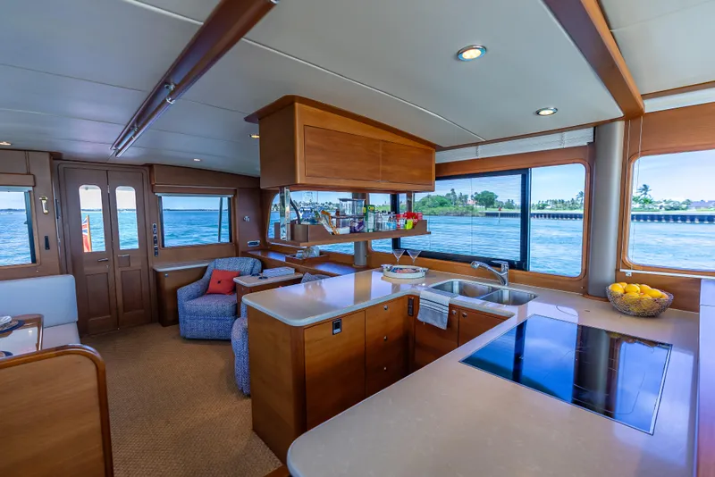 Slide: The Image of Luxurious 2018 Grand Banks GB60 yacht interior with modern kitchen and scenic ocean views. - 46