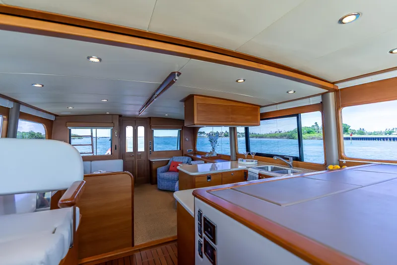 Slide: The Image of Luxurious 2018 Grand Banks GB60 yacht interior with panoramic windows and elegant wood finishes. - 48