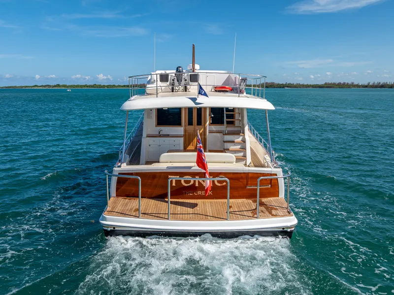 Slide: The Image of 2018 Grand Banks GB60 yacht cruising on open water, rear view. - 8