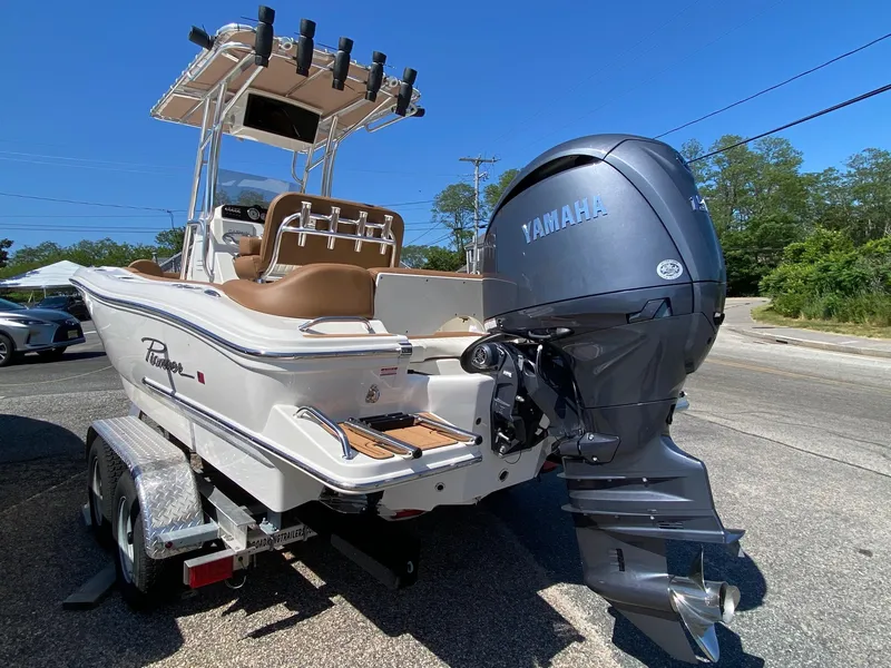 Slide: The Image of 2025 Pioneer 202 Islander boat with Yamaha engine on trailer, parked outdoors. - 3