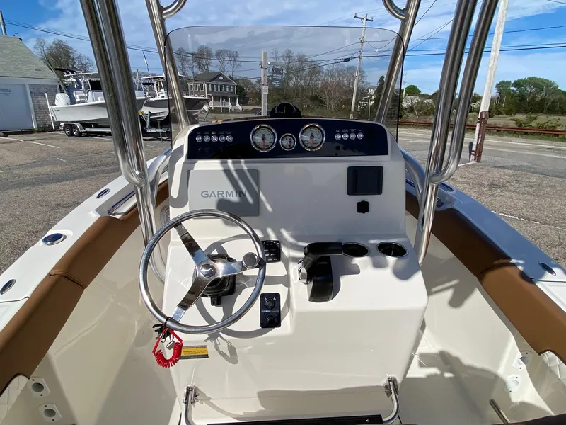 Slide: The Image of 2025 Pioneer 202 Islander boat console with T-top and clear sky background. - 5