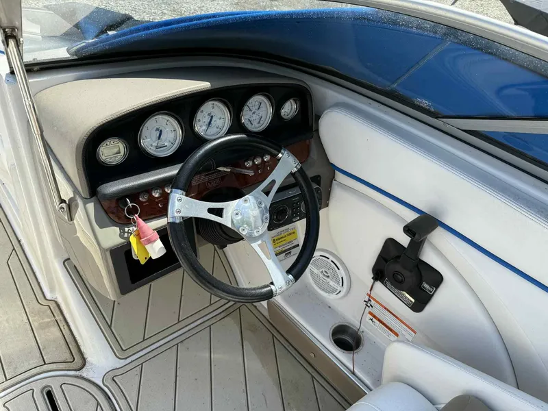 Slide: The Image of 2008 Four Winns 200 Horizon boat dashboard with steering wheel and gauges. - 12