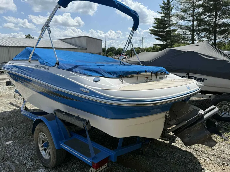 Slide: The Image of 2008 Four Winns 200 Horizon boat with blue cover on trailer, outdoors. - 5