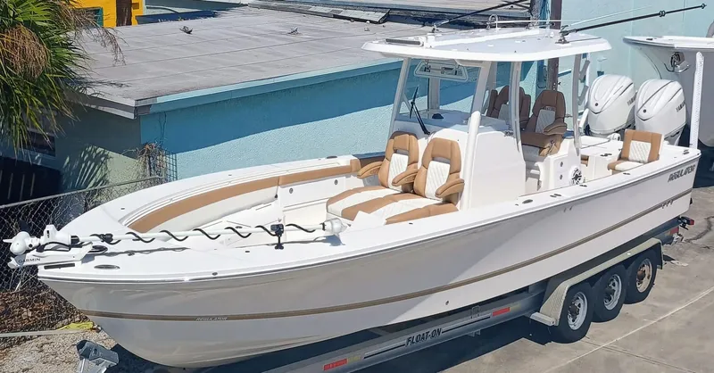 The Image of 2025 Regulator 30XO boat on trailer, featuring dual engines and luxurious seating. - 0