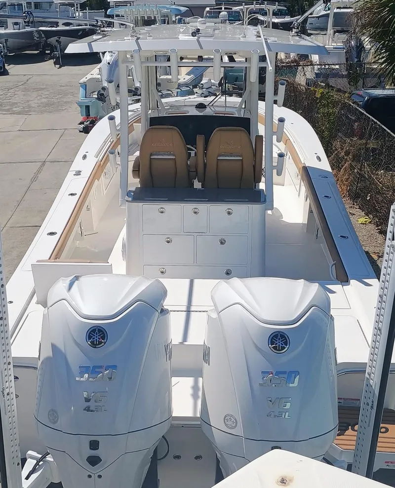 Slide: The Image of 2025 Regulator 30XO boat with dual Yamaha engines, docked at a marina. - 3