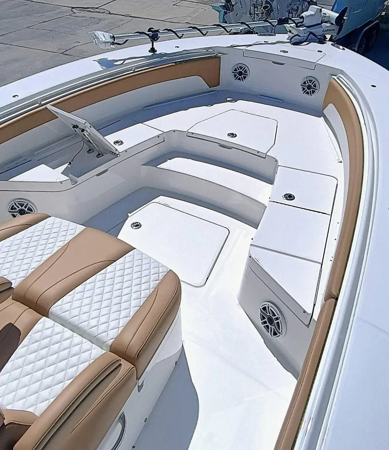 Slide: The Image of 2025 Regulator 30XO boat interior with white and tan seating, modern design. - 4
