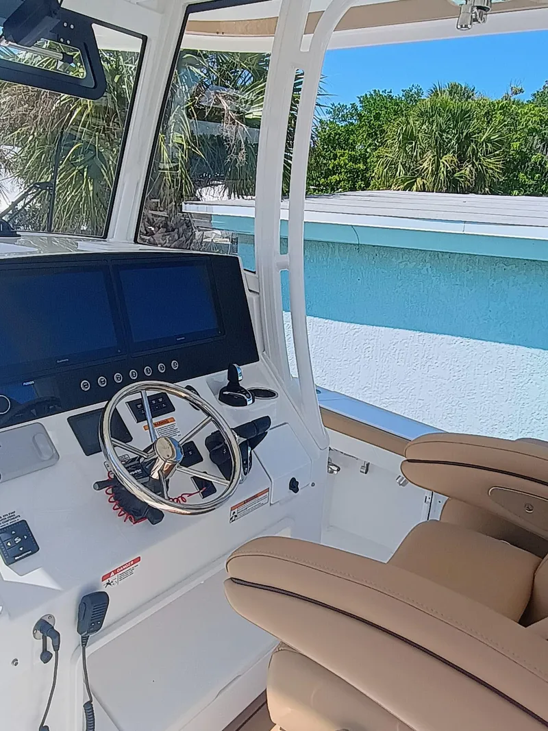 Slide: The Image of 2025 Regulator 30XO boat cockpit with modern controls and comfortable seating. - 5