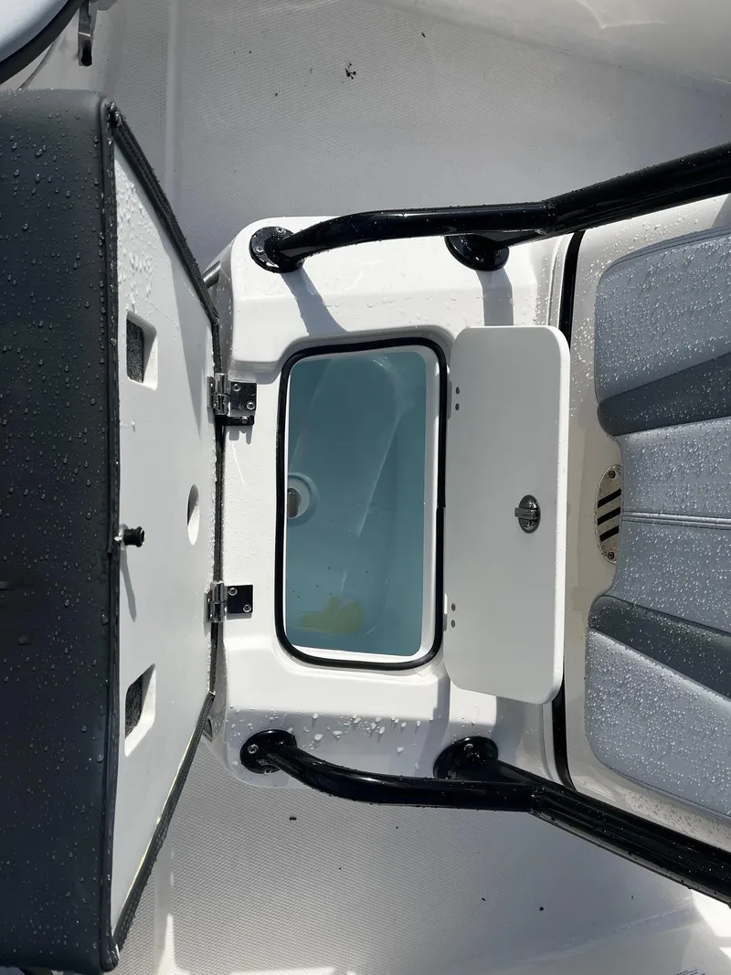 Slide: The Image of 2025 Robalo 206 Cayman boat interior with open storage compartment. - 21