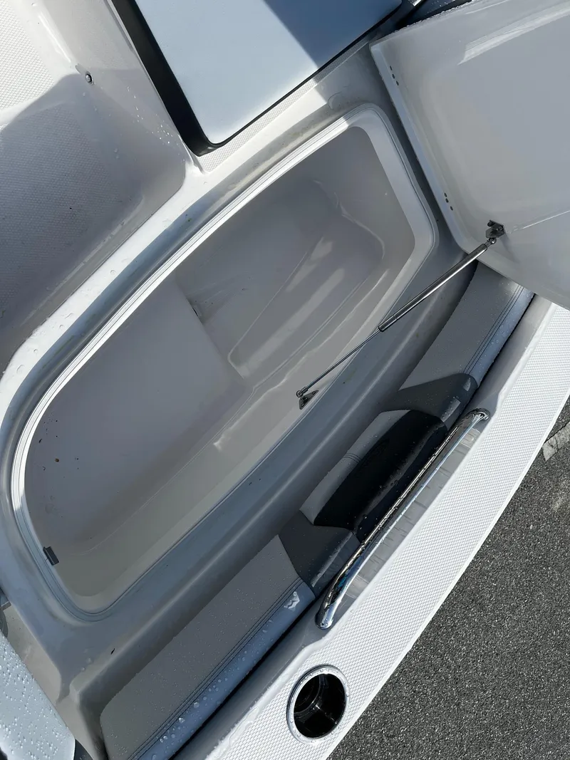 Slide: The Image of Open storage compartment on 2025 Robalo 206 Cayman boat, showcasing interior space. - 3
