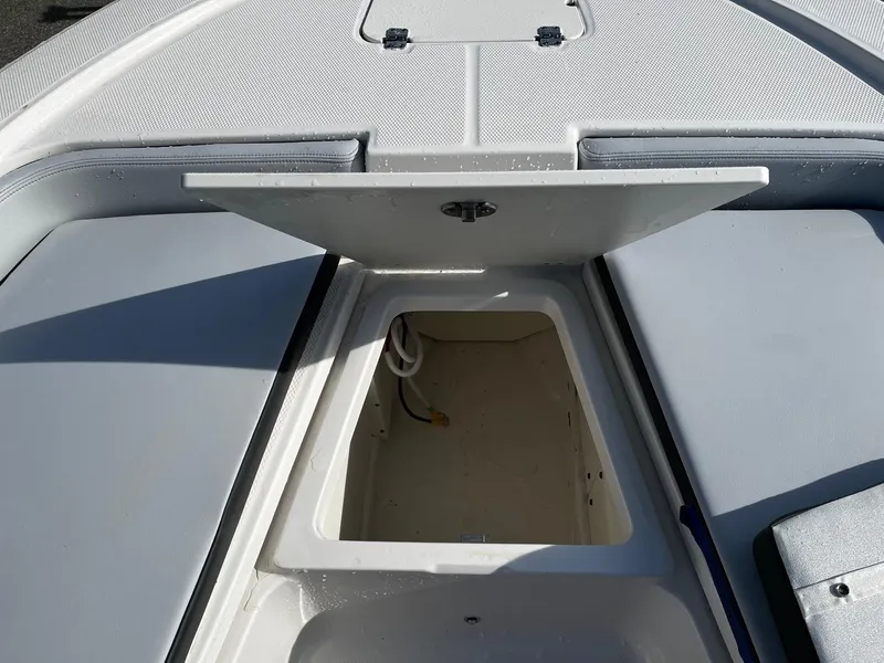 Slide: The Image of 2025 Robalo 206 Cayman boat storage compartment with open hatch. - 4