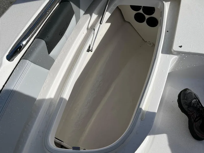 Slide: The Image of Open storage compartment on 2025 Robalo 206 Cayman boat, showing interior details. - 5