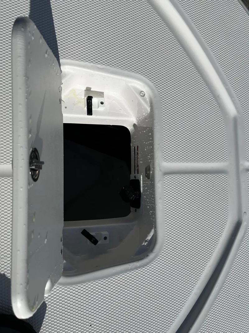 Slide: The Image of Open storage compartment on 2025 Robalo 206 Cayman boat deck. - 7