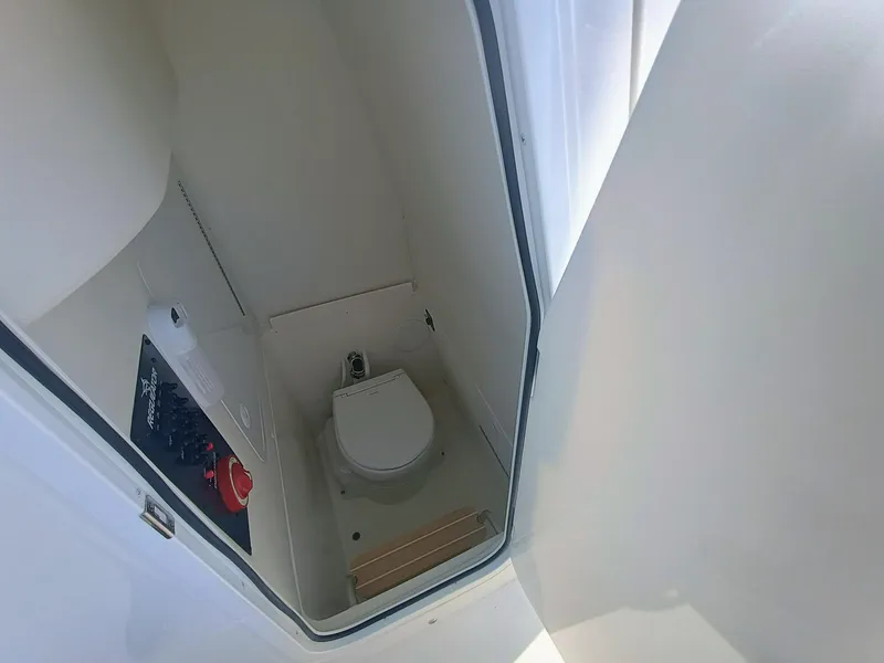 Slide: The Image of 2025 Regulator 23 boat interior with compact marine toilet and control panel. - 10