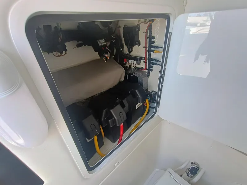 Slide: The Image of Electrical compartment of 2025 Regulator 23 boat, showcasing wiring and battery setup. - 12