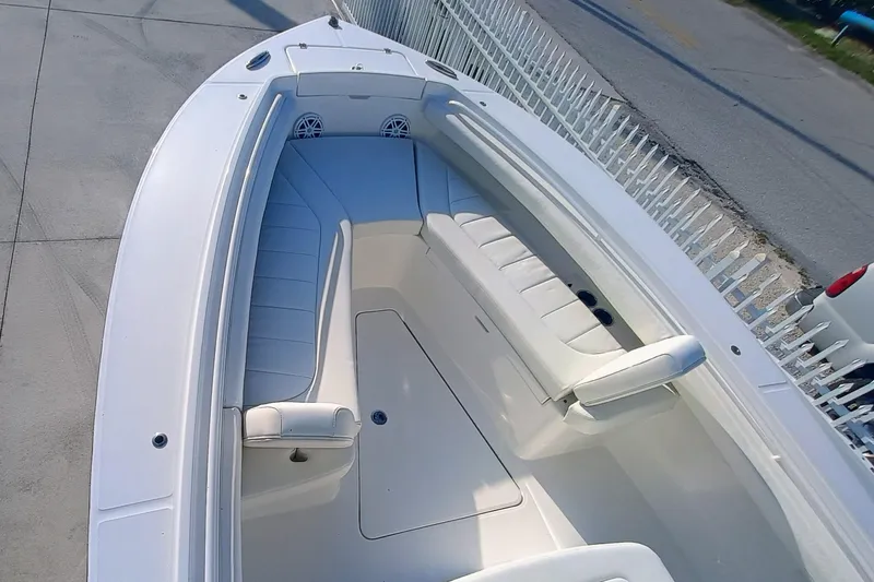 Slide: The Image of 2025 Regulator 23 boat interior with white seating and sleek design. - 16