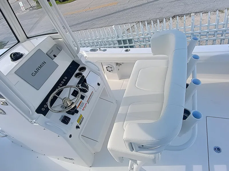 Slide: The Image of 2025 Regulator 23 boat cockpit with Garmin navigation and white seating. - 23