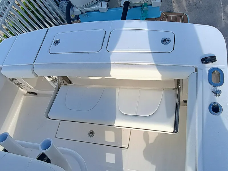 Slide: The Image of 2025 Regulator 23 boat interior with white seating and storage compartments. - 24